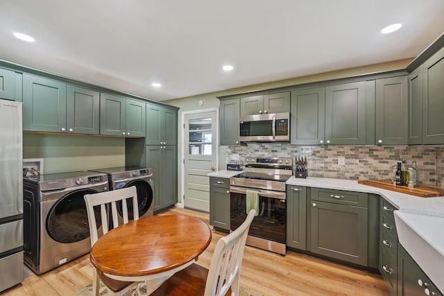 320 W Liberty St, Bucyrus, OH 44820 - kitchen featuring stainless steel appliances, washer and clothes dryer, green cabinets, and recessed lighting