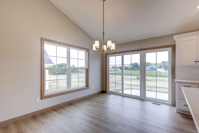 551 Cannondale Ave, Johnstown, OH 43031 - unfurnished dining area with light wood-style flooring, a chandelier, and vaulted ceiling