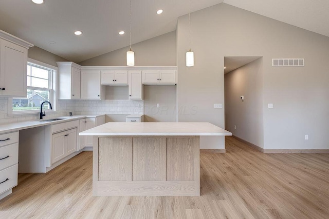 551 Cannondale Ave, Johnstown, OH 43031 - kitchen featuring light wood-style floors, a kitchen island, decorative backsplash, white cabinets, and recessed lighting
