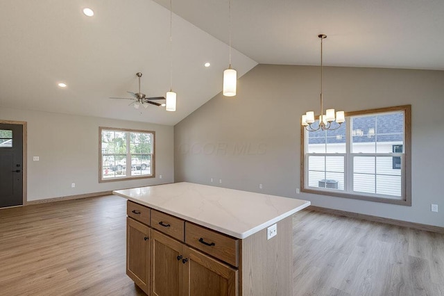 551 Cannondale Ave, Johnstown, OH 43031 - kitchen with open floor plan, lofted ceiling, light wood-style floors, a center island, and decorative light fixtures