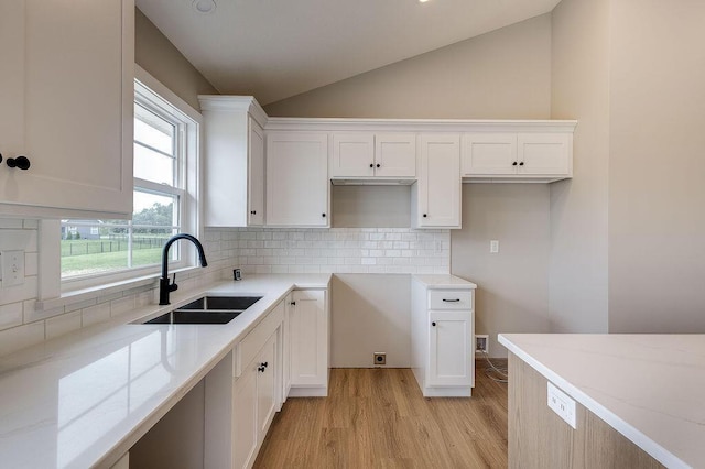 551 Cannondale Ave, Johnstown, OH 43031 - kitchen featuring vaulted ceiling, light stone counters, light wood-style flooring, white cabinets, and backsplash