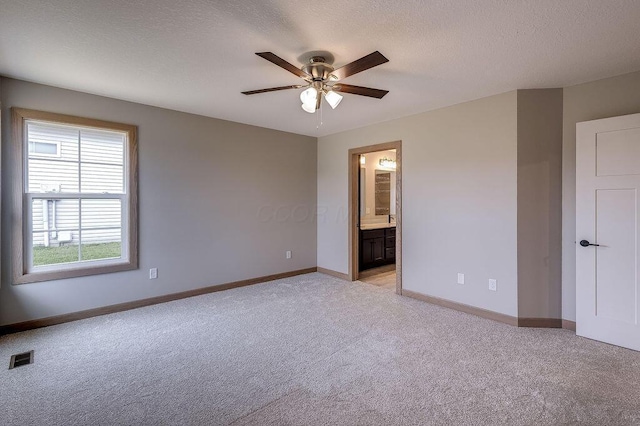 551 Cannondale Ave, Johnstown, OH 43031 - unfurnished bedroom featuring light carpet, ensuite bathroom, a textured ceiling, and ceiling fan