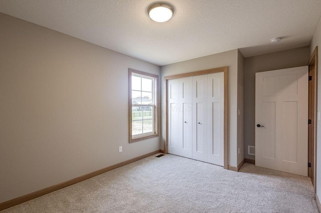 551 Cannondale Ave, Johnstown, OH 43031 - unfurnished bedroom with light colored carpet, a closet, and a textured ceiling