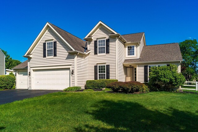 4694 Tayport Ave, Grove City, OH 43123 - traditional-style home featuring a front yard, driveway, an attached garage, and a shingled roof