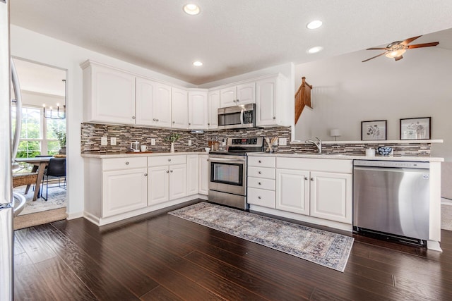 4694 Tayport Ave, Grove City, OH 43123 - kitchen with appliances with stainless steel finishes, a peninsula, backsplash, white cabinets, and recessed lighting