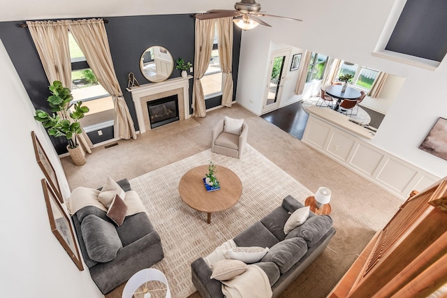 4694 Tayport Ave, Grove City, OH 43123 - carpeted living room featuring plenty of natural light, a fireplace with flush hearth, and a ceiling fan