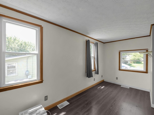 1018 Harrison Ave, Lancaster, OH 43130 - spare room featuring dark wood-style flooring, a textured ceiling, and ornamental molding