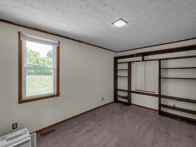 1018 Harrison Ave, Lancaster, OH 43130 - unfurnished bedroom with carpet floors, a textured ceiling, crown molding, and heating unit