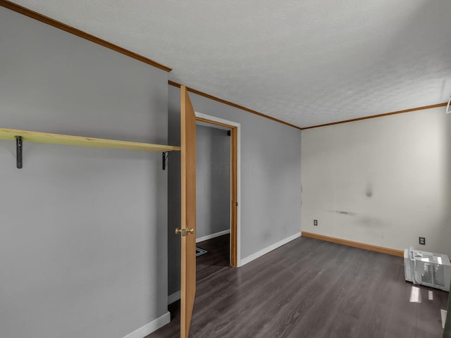 1018 Harrison Ave, Lancaster, OH 43130 - unfurnished bedroom with dark wood-style flooring, crown molding, and a textured ceiling