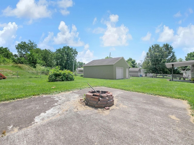 1018 Harrison Ave, Lancaster, OH 43130 - view of patio with a fire pit, a detached garage, and an outbuilding