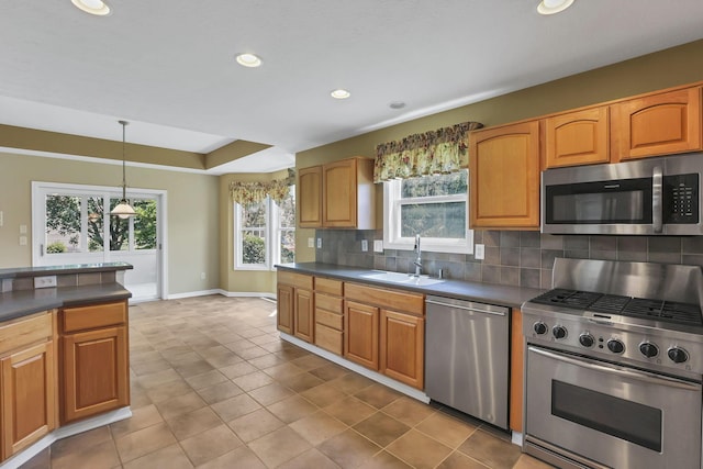 7511 Windsor Dr, Dublin, OH 43016 - kitchen featuring stainless steel appliances, dark countertops, backsplash, recessed lighting, and decorative light fixtures