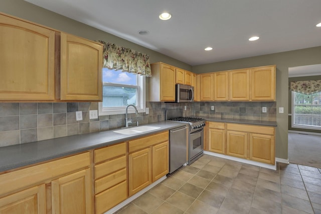 7511 Windsor Dr, Dublin, OH 43016 - kitchen with stainless steel appliances, light brown cabinets, plenty of natural light, recessed lighting, and tasteful backsplash