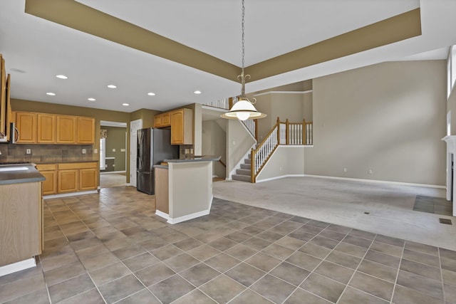 7511 Windsor Dr, Dublin, OH 43016 - kitchen featuring light carpet, freestanding refrigerator, recessed lighting, open floor plan, and tasteful backsplash