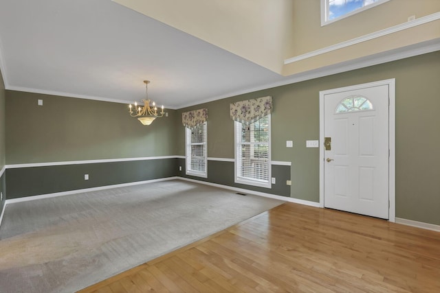 7511 Windsor Dr, Dublin, OH 43016 - entryway with light wood-style floors, a chandelier, and crown molding