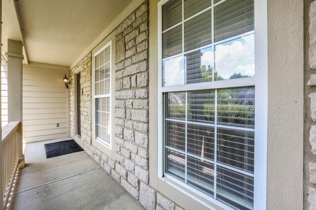 7511 Windsor Dr, Dublin, OH 43016 - doorway to property featuring a porch and stone siding