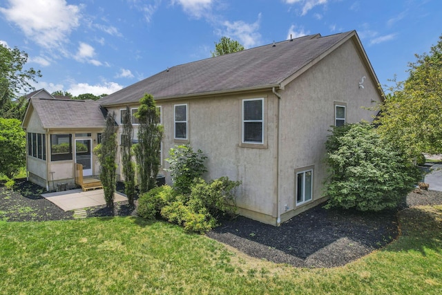 7511 Windsor Dr, Dublin, OH 43016 - back of property with stucco siding, a yard, a sunroom, and roof with shingles