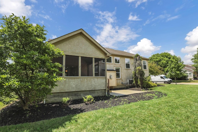 7511 Windsor Dr, Dublin, OH 43016 - rear view of property with stucco siding, a yard, and a sunroom