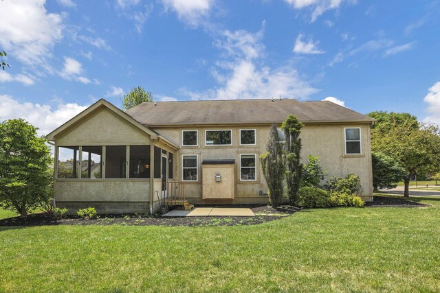 7511 Windsor Dr, Dublin, OH 43016 - rear view of house featuring a sunroom, a yard, and stucco siding