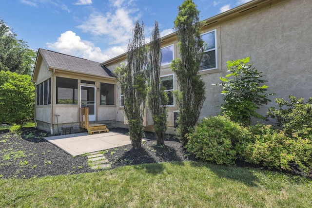 7511 Windsor Dr, Dublin, OH 43016 - view of front of house with a sunroom, stucco siding, a front lawn, and entry steps
