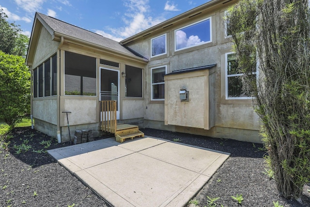7511 Windsor Dr, Dublin, OH 43016 - back of property with a sunroom, a patio area, and stucco siding