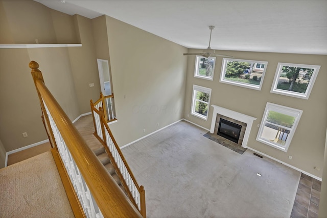 7511 Windsor Dr, Dublin, OH 43016 - unfurnished living room featuring a ceiling fan, a fireplace, lofted ceiling, and carpet floors