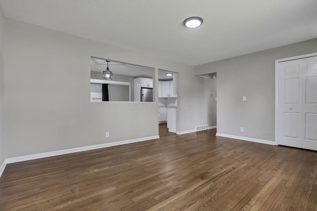 3171 Haskell Dr, Columbus, OH 43219 - unfurnished living room with dark wood finished floors and baseboards