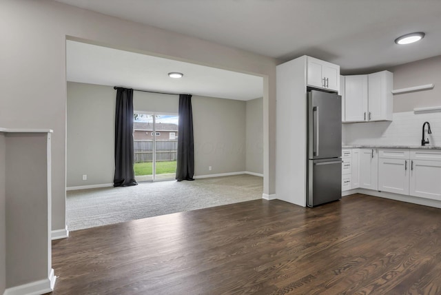 3171 Haskell Dr, Columbus, OH 43219 - kitchen featuring freestanding refrigerator, open shelves, white cabinets, decorative backsplash, and dark wood finished floors