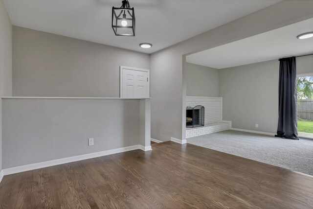 3171 Haskell Dr, Columbus, OH 43219 - unfurnished living room with a brick fireplace and dark wood-type flooring