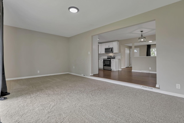 3171 Haskell Dr, Columbus, OH 43219 - unfurnished living room featuring dark carpet and baseboards
