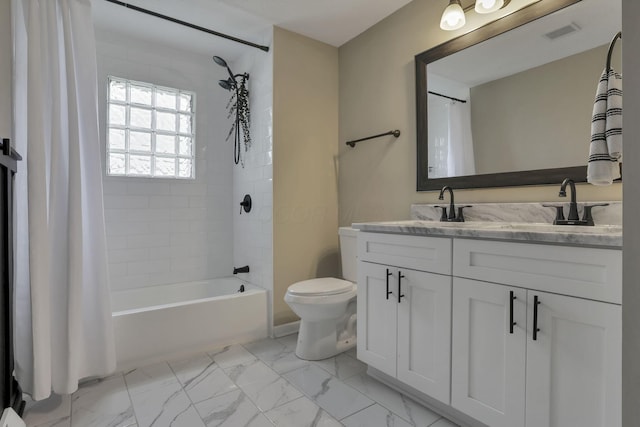3171 Haskell Dr, Columbus, OH 43219 - full bathroom with double vanity, marble finish floors, and shower / bath combo with shower curtain