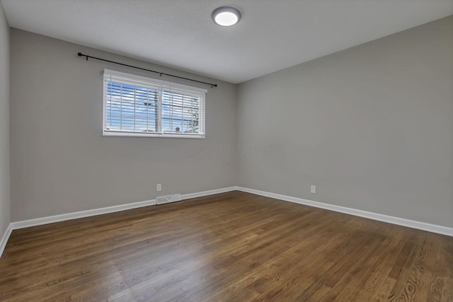 3171 Haskell Dr, Columbus, OH 43219 - unfurnished room with baseboards and dark wood-style flooring