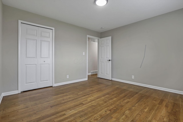 3171 Haskell Dr, Columbus, OH 43219 - unfurnished bedroom with dark wood finished floors and a closet