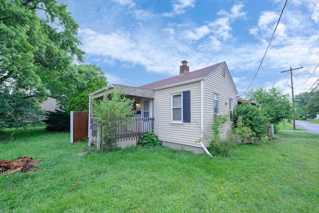 3166 Howey Rd, Columbus, OH 43224 - view of property exterior with a chimney and a lawn
