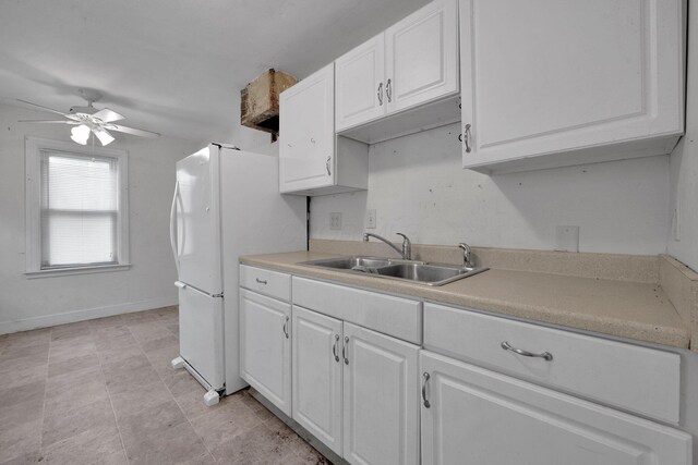 3166 Howey Rd, Columbus, OH 43224 - kitchen with white cabinets, ceiling fan, light countertops, and freestanding refrigerator