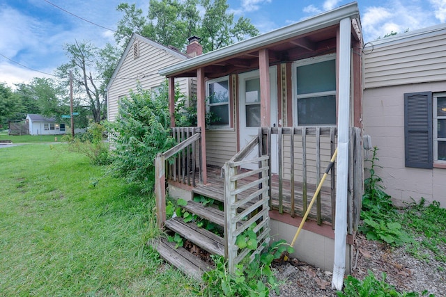 3166 Howey Rd, Columbus, OH 43224 - view of exterior entry featuring a chimney and a yard