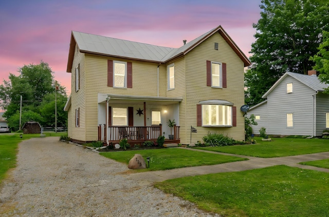 115 Maple Ave, Utica, OH 43080 - traditional-style home featuring a porch, a lawn, dirt driveway, and a metal roof