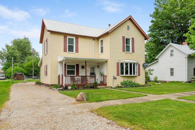 115 Maple Ave, Utica, OH 43080 - view of front facade with a porch, a front lawn, gravel driveway, a standing seam roof, and a metal roof