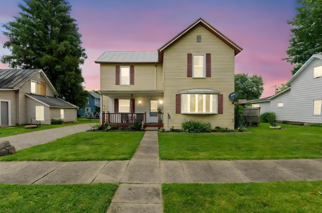 115 Maple Ave, Utica, OH 43080 - traditional home with a porch, a standing seam roof, a yard, and a metal roof