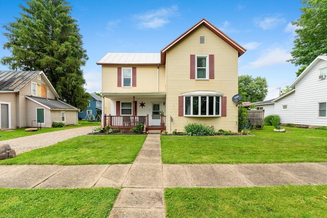 115 Maple Ave, Utica, OH 43080 - traditional home with covered porch, a front lawn, driveway, a metal roof, and a standing seam roof