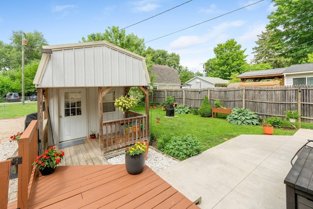 115 Maple Ave, Utica, OH 43080 - wooden terrace featuring a fenced backyard, an outdoor structure, and a patio