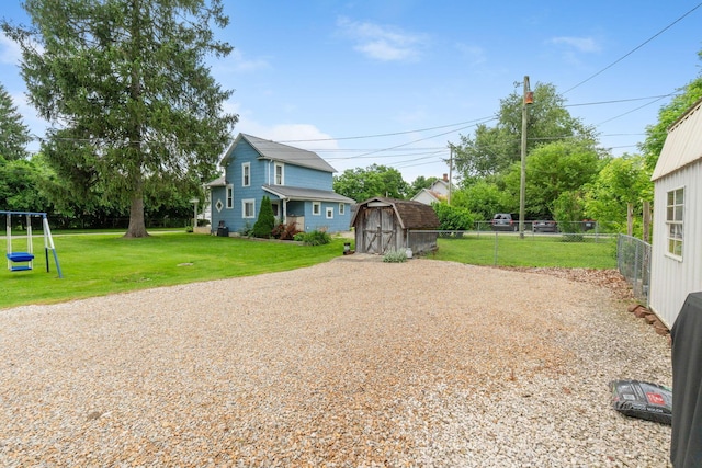 115 Maple Ave, Utica, OH 43080 - view of yard featuring a shed, gravel driveway, and a playground