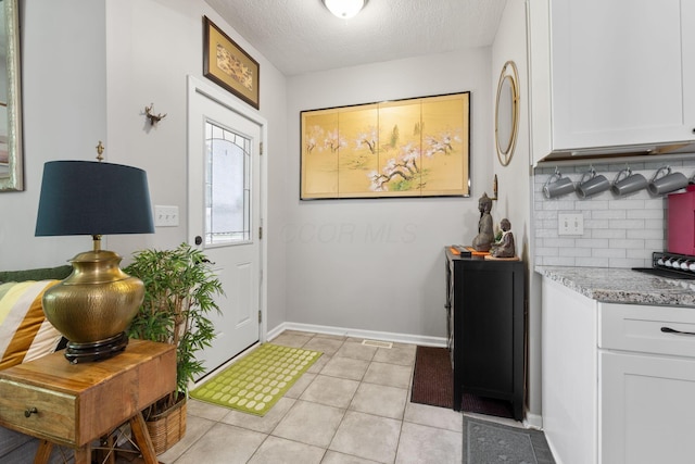 115 Maple Ave, Utica, OH 43080 - foyer entrance with light tile patterned flooring and a textured ceiling