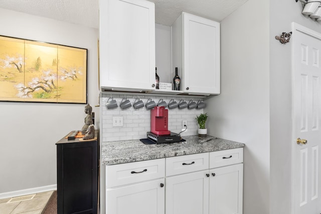 115 Maple Ave, Utica, OH 43080 - indoor dry bar featuring tasteful backsplash, a textured ceiling, and tile patterned floors