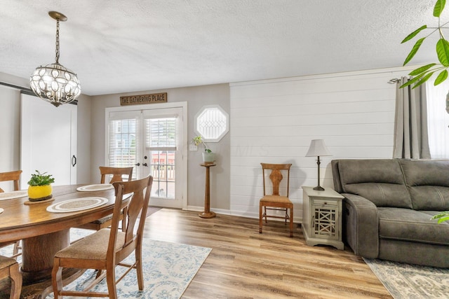 115 Maple Ave, Utica, OH 43080 - dining area with a textured ceiling, light wood-type flooring, and a chandelier