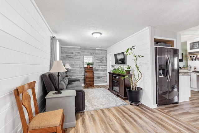 115 Maple Ave, Utica, OH 43080 - living area with light wood-type flooring, a glass covered fireplace, and a textured ceiling