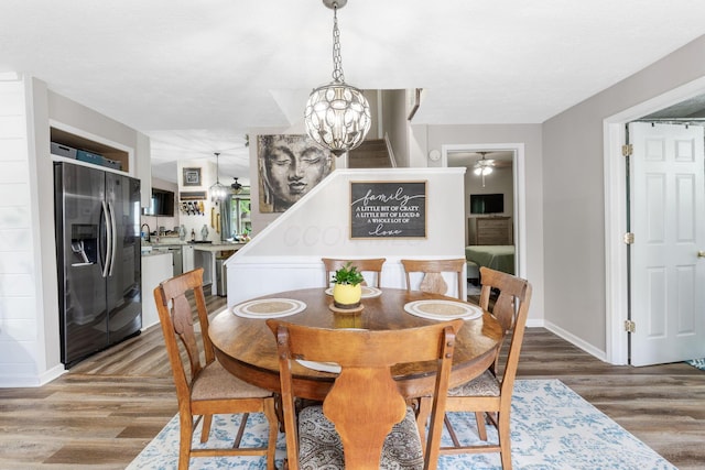 115 Maple Ave, Utica, OH 43080 - dining area with a chandelier, wood finished floors, and ceiling fan