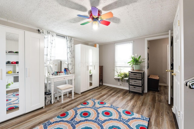 115 Maple Ave, Utica, OH 43080 - bedroom featuring wood finished floors, a textured ceiling, and a ceiling fan