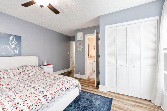 115 Maple Ave, Utica, OH 43080 - bedroom with light wood-style flooring, a textured ceiling, connected bathroom, and a ceiling fan