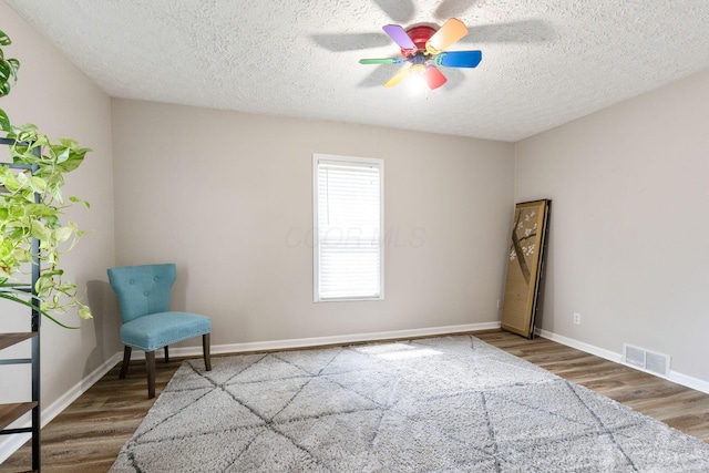 115 Maple Ave, Utica, OH 43080 - unfurnished room featuring wood finished floors, a textured ceiling, and a ceiling fan