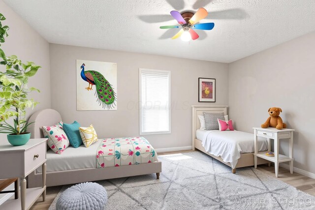 115 Maple Ave, Utica, OH 43080 - bedroom with a textured ceiling, ceiling fan, and wood finished floors